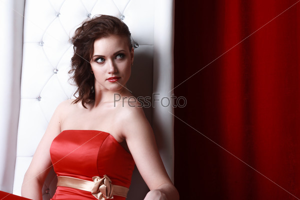 princess woman in a red dresssitting on throne