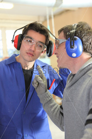 Men talking in a factory
