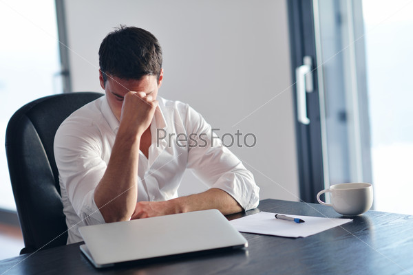 frustrated with problems young business man working on laptop\
computer at home