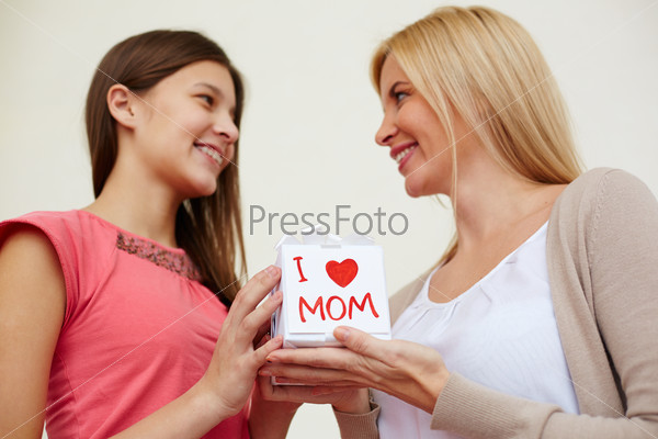 Teenage girl congratulating her mom on special occasion