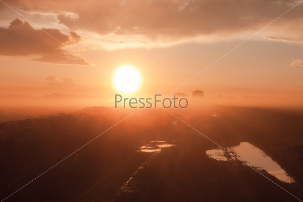 Magic fog over rural farm village road with mud and puddles, stock photo