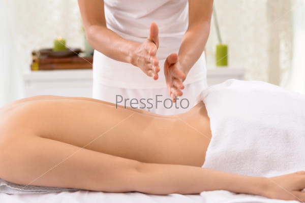 Close-up of therapist massaging female back