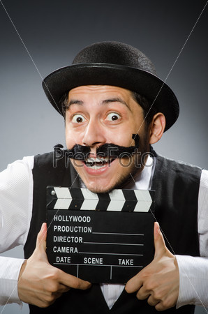 Funny man with movie clapper board , stock photo