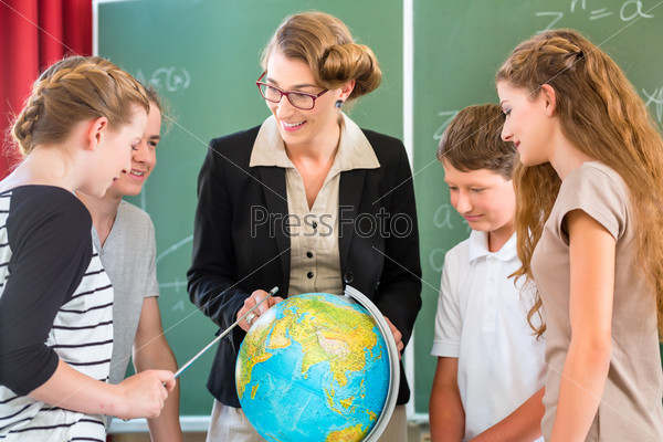 Students or pupils having group work while geography lesson and the teacher test or educate them in school or class
