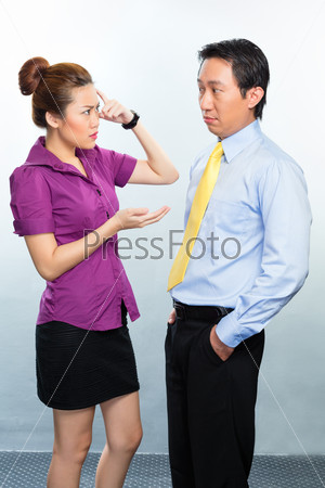 Angry argument among colleagues in an Asian business office