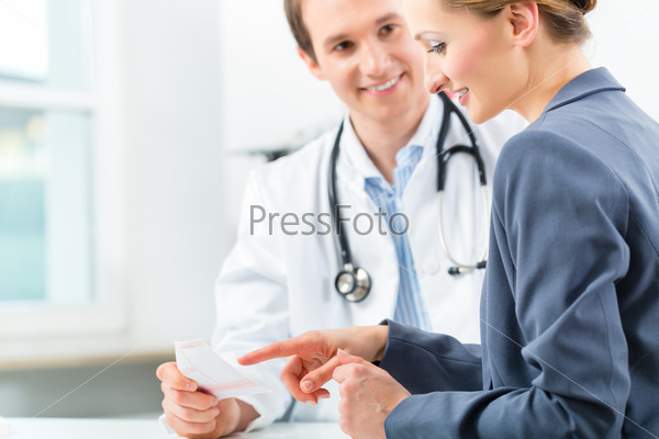 Young doctor with his patient in a consultation explaining something