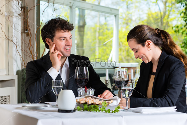 Businesspeople having business lunch in a fine dining restaurant
