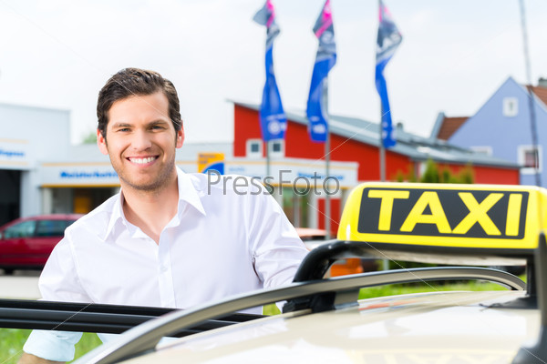 Experienced taxi driver in front of his taxi, waiting for a passenger, stock photo