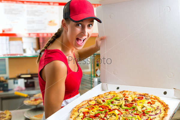 Woman holding a whole pizza in hand and asking you to ordering a pizza