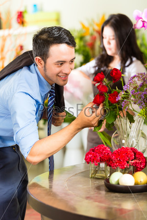 Young Asian or Indonesian Man is interested for a bouquet Roses