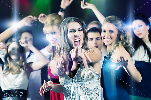 Young people dancing in club or disco party, the girls and boys, friends, having fun, stock photo