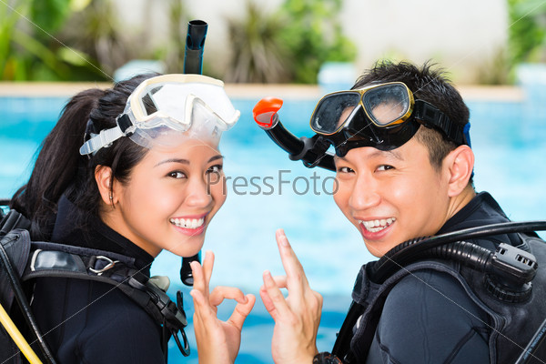 Asian people at the diver Course in diving school in wetsuit with an oxygen tank