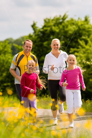 Family jogging for sport outdoors with the kids on summer day, stock photo