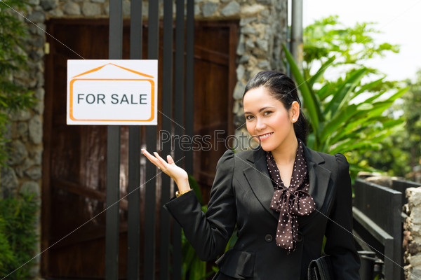 Real estate - Young Indonesian realtor showing an house or apartment, it could be the landlord too
