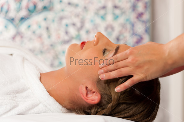 Wellness - woman getting massage in Spa; it is a massage for the head