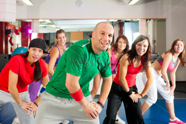 Fitness - Young people doing dance training or dance workout\
in a gym