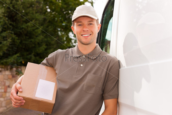Postal service - delivery of a package through a delivery service; the postman is leaning on his van