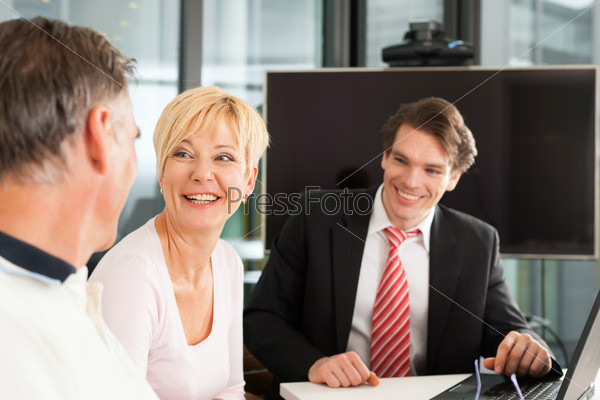 Mature couple with young financial consultant - they are planning their retirement
