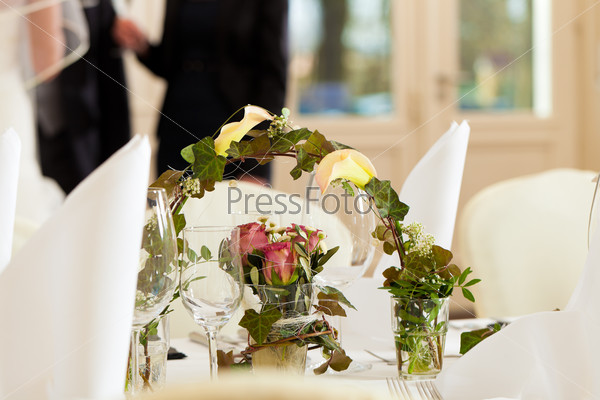 Wedding table at a wedding feast decorated with flowers