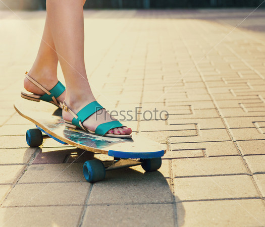 Teen girl on longboard on the street