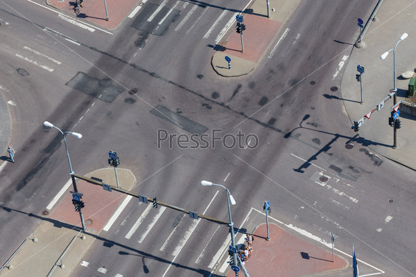 high angle view of an empty street intersection with cross walk markings, traffic signal lights