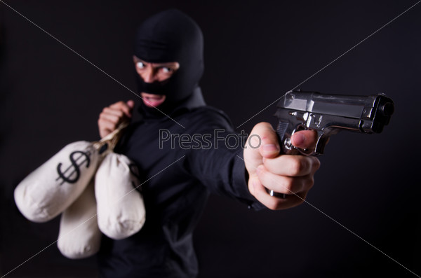 Man wearing balaclava with gun, stock photo
