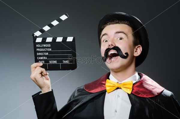 Funny man with movie clapper board, stock photo