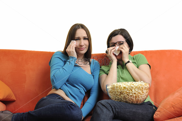female friends eating popcorn and watching tv at home