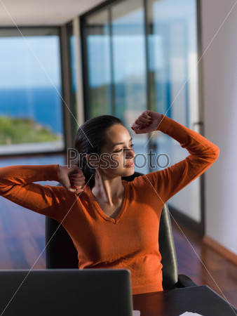 relaxed young woman at home working