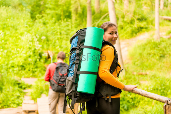 Young couple with backpacks in a hike, stock photo