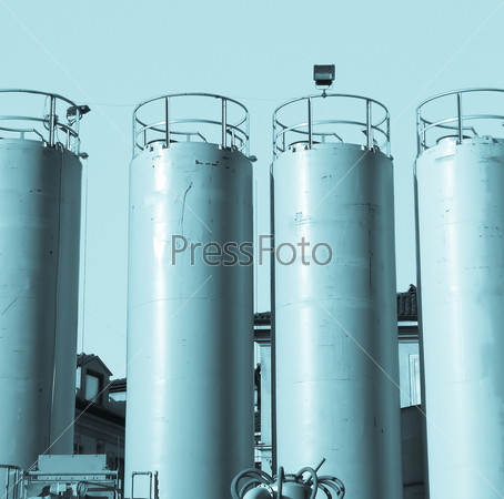 Yellow water tanks over a blue sky - cool cyanotype