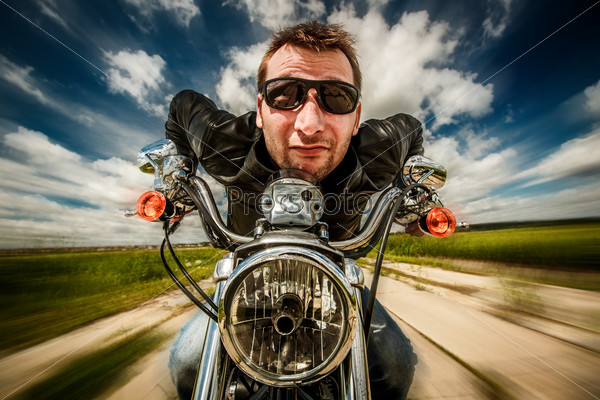 Funny Biker In Sunglasses And Leather Jacket Racing On The Road (Fisheye Lens)