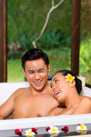 Indonesian couple having wellness bath in spa