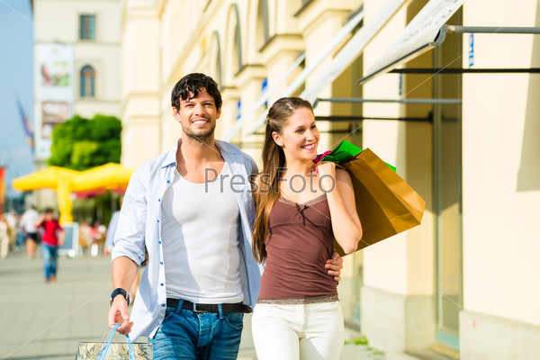 Young couple shopping in inner city ith shopping bags spending money