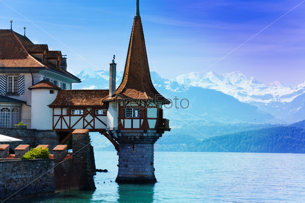 Beautiful Little Tower Of Oberhofen Castle In The Thun Lake With Mountains On Background In Switzerland, Near Bern