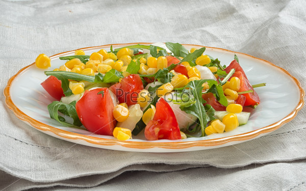 fresh vegetable salad with corn, tomato, arugula and mozzarella cheese
