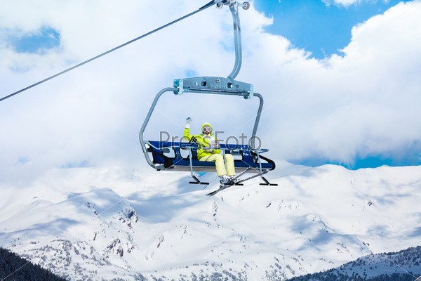Happy skier in on the ski lift