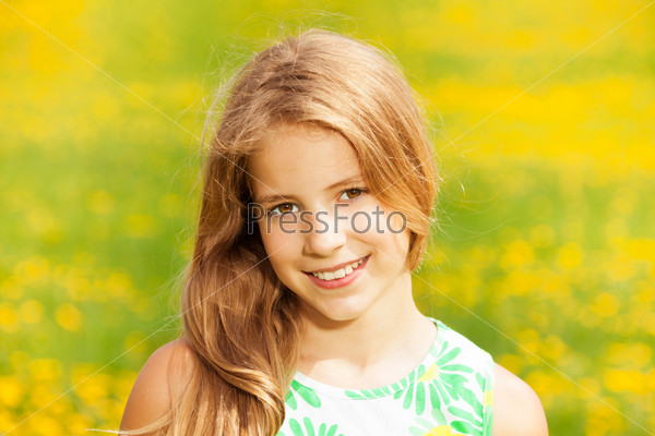 Close portrait of happy smiling Caucasian girl with yellow field on background