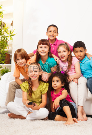Group of kids with TV remote controll