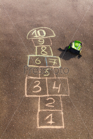 Hopscotch Game Drawn On The Asphalt And Kids Rucksack Laying Nearby