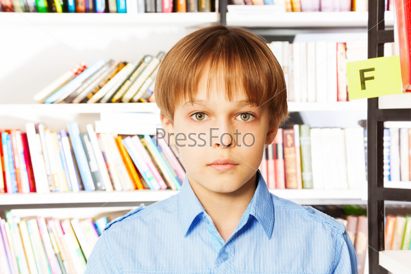 Portrait of serious boy in the library