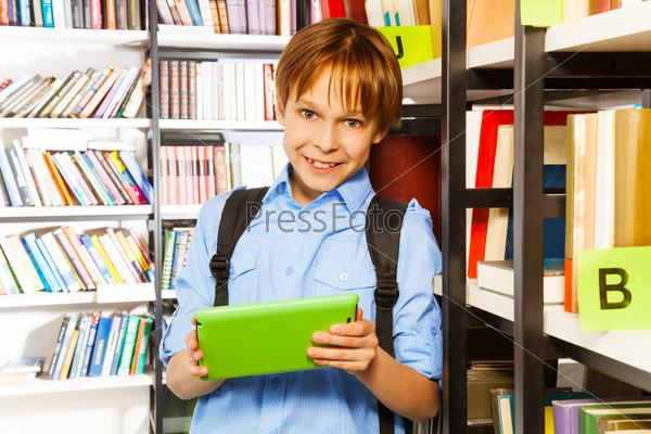 Elementary student with tablet in library