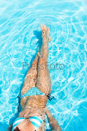 Body of young woman in the crystal-clear water