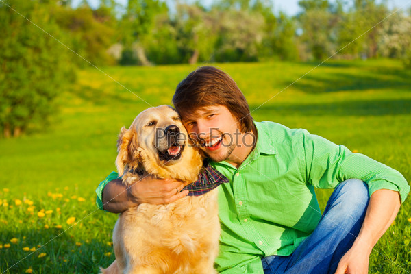 Happy dog and man in the park together
