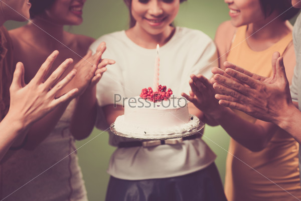 Young girl holding birthday cake