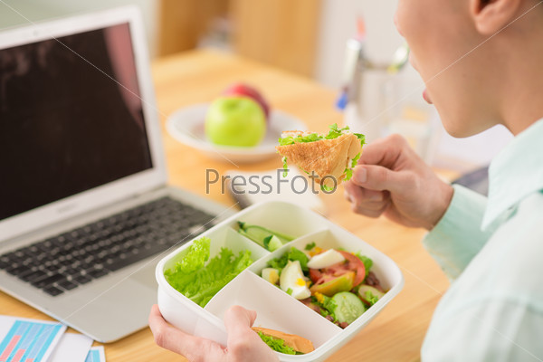 Businessman eating salad for lunch