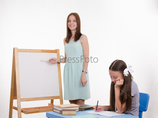 The teacher explains task at blackboard