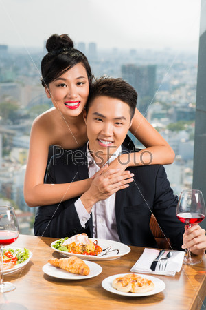 Portrait of happy Vietnamese couple in a luxurious restaurant