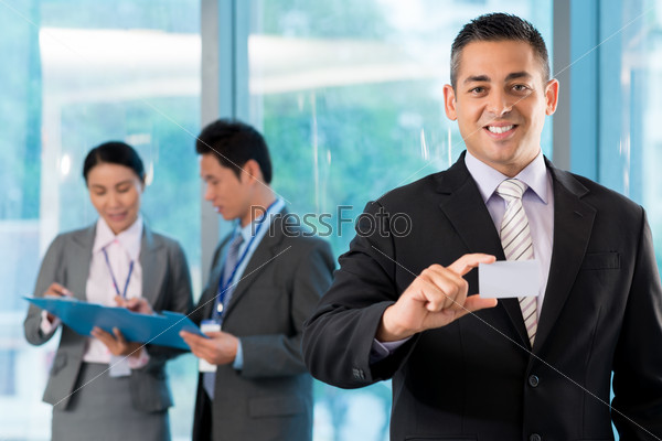 Handsome businessman showing blank paper visit card