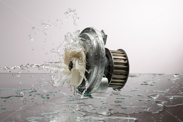 Auto parts, engine cooling pump in water splash on gray gradient background, stock photo